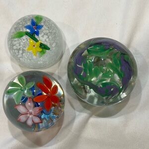 Set of three glass paperweights with floral design